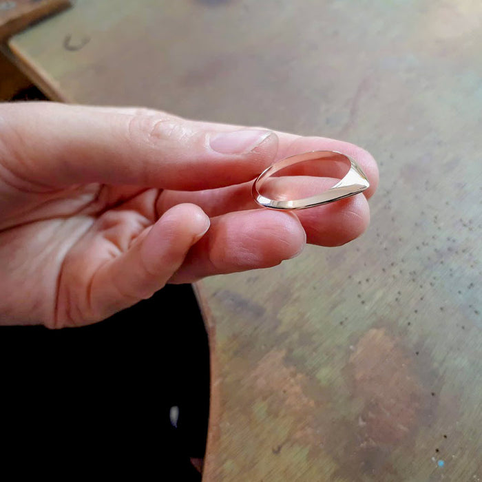 A thin pointed silver ring