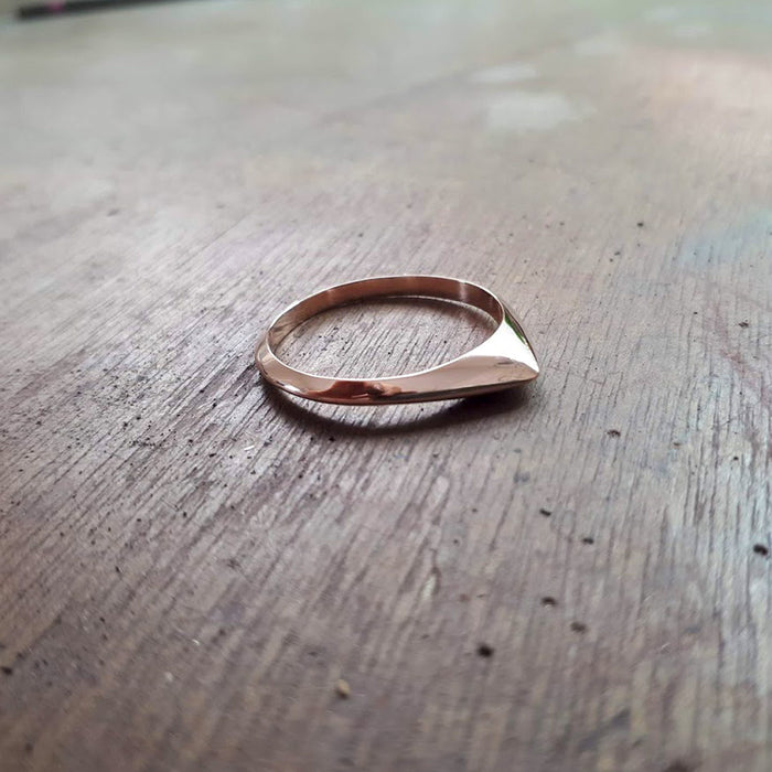 A thin pointed silver ring