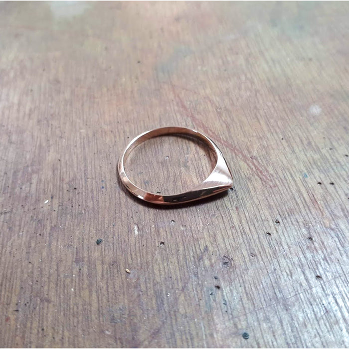 A thin pointed silver ring